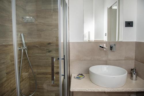 a bathroom with a sink and a shower at Conero Suites in Numana
