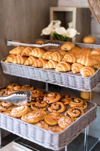 a bunch of pastries on trays in a bakery at Logis Hôtels- Hôtel et Restaurant Domaine de Fompeyre in Bazas