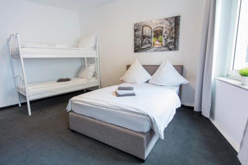 a bedroom with a bed and a bunk bed at Berolina Haus in Düsseldorf