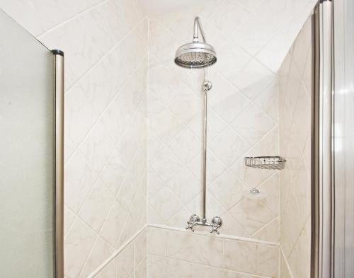 a shower stall with a shower head in a bathroom at Villa Tranquilla in Estepona