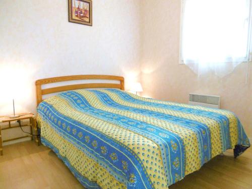 サルゾーにあるAppartement Polのベッドルーム1室(青と黄色の毛布付きのベッド1台付)