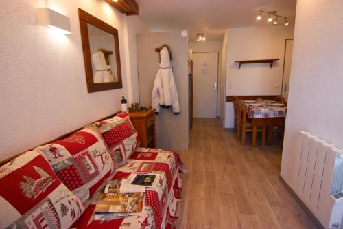 a living room with a couch and a table at Altineige Appartements VTI in Val Thorens