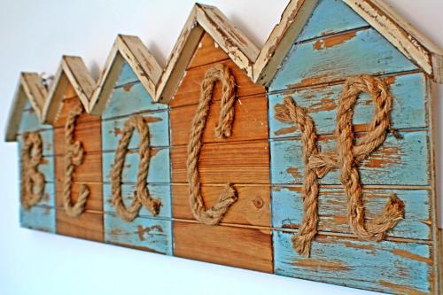 a wooden house with the word home written on it at Playa Hotel - Cavancha in Iquique