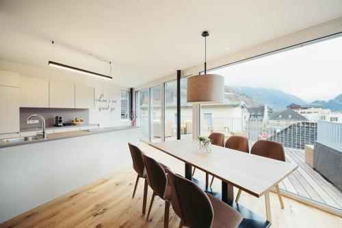 a kitchen and dining room with a table and chairs at adler alpen apartments in Schruns