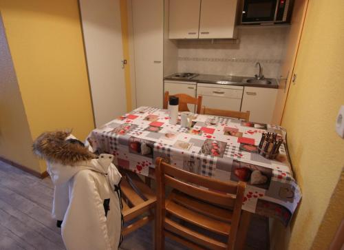 a kitchen with a table with a table cloth on it at Altineige Appartements VTI in Val Thorens