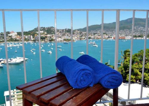 a blue towel sitting on top of a wooden bench at Alba Suites Acapulco in Acapulco