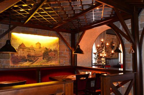 a dining room with a painting on the wall at Complex Mukhomor in Poltava