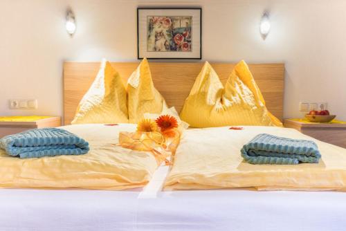 a bed with two pillows on top of it at Naturpension Mühlhof in Neukirchen am Großvenediger
