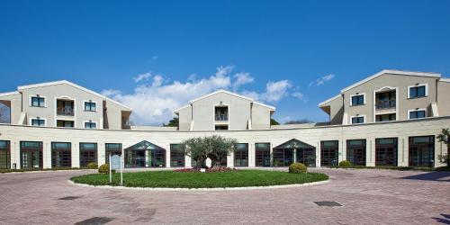 a large brick building with a large window at Grand Hotel Villa Itria Congress & Spa in Viagrande