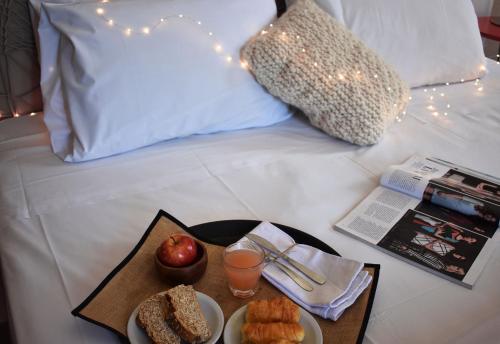 a tray with food and drinks on a bed at Esplendor by Wyndham Buenos Aires in Buenos Aires
