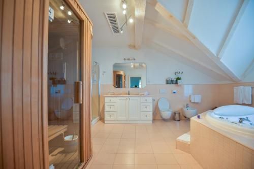 
a bathroom with a sink, toilet and bathtub at Hotel Draga di Lovrana in Lovran
