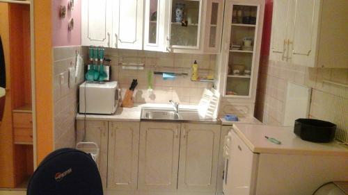 a kitchen with a sink and a microwave at Apartments Mia in Podgora