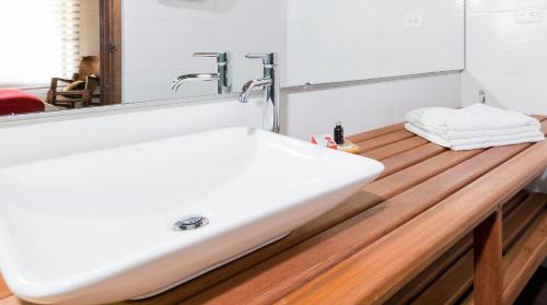 a bathroom with a white sink and a mirror at San Mateo Hotel Campestre in Nobsa