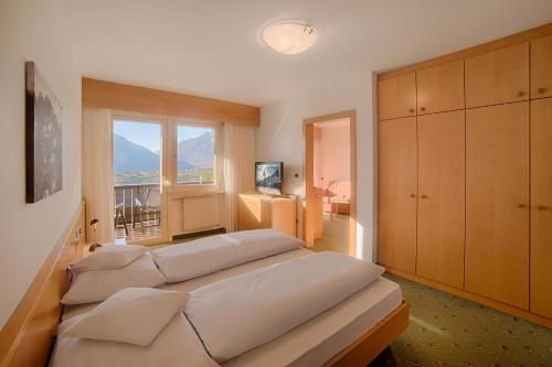 Un dormitorio con dos camas y una ventana. en Appartment Maria, en Scena