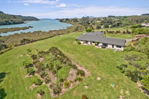 an aerial view of a house on a hill next to a river at Okura River Estate Getaway in Auckland