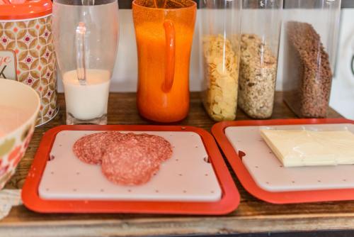 a table with two plates of food and containers of food at Hostel of the Sun in Naples