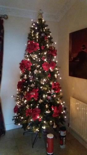 a christmas tree with red roses on it at Greencastle B&B in Kilkeel