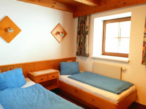 a bedroom with two beds and a window at Haus Granbichler in Vent