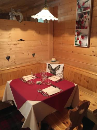 a dining room with a table with a cat on it at Hotel Gran Baita in Gressoney-Saint-Jean