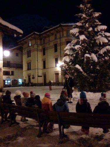 a group of people sitting in front of a christmas tree at Hotel Gran Baita in Gressoney-Saint-Jean