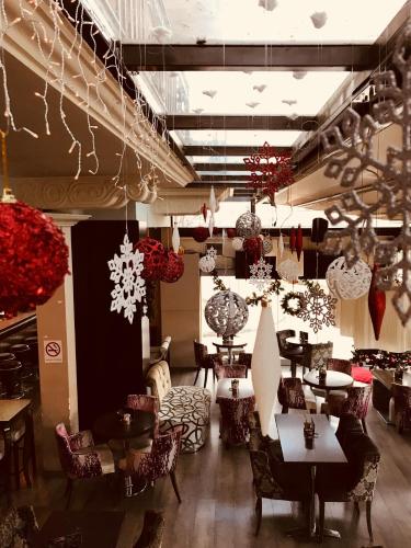 a restaurant with tables and chairs and decorations at Yiannis Apartments in Ioannina