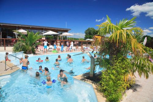 un groupe de personnes dans une piscine dans l'établissement Camping Haliotis, à Pontorson