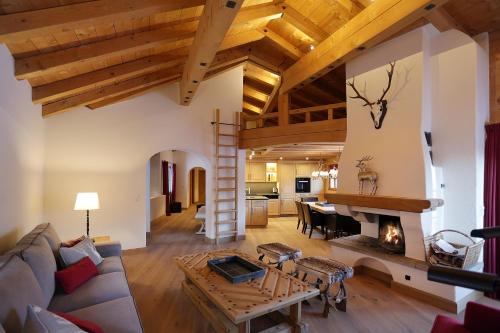 a living room with a couch and a fireplace at Chalet Chesa Surlej, Davos in Davos