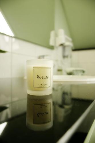 a bottle ofrax sitting on a counter in a bathroom at Hotel am Kulturplatz in Rastatt