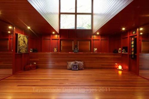 a large room with a large window and a wooden floor at Runawaytomaleny in Maleny