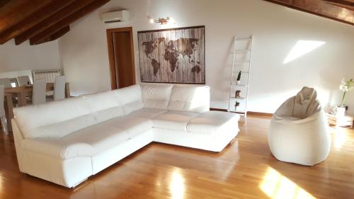 a living room with a white couch and a chair at Donizetti Royal in Bergamo