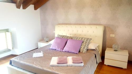a bedroom with a bed with two towels on it at Donizetti Royal in Bergamo