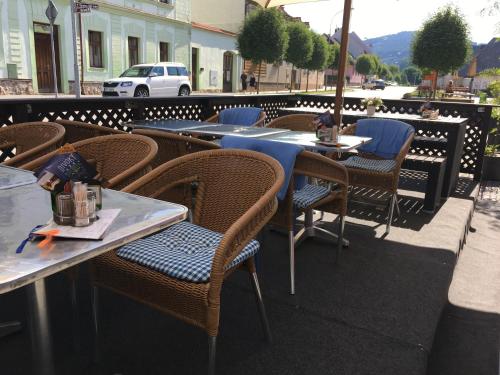 a row of tables and chairs on a patio at Penzion Na Solné stezce in Kašperské Hory