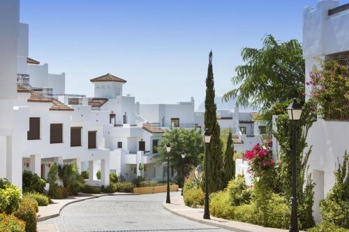 a street in front of a white building at Apartment Marina Alcaidesa 2 beds Golf & Beach in La Alcaidesa
