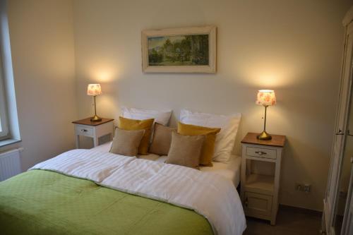 a bedroom with a bed with two night stands with lamps at Hotel Apartments Belgium 3 - HAB 3 in Geel