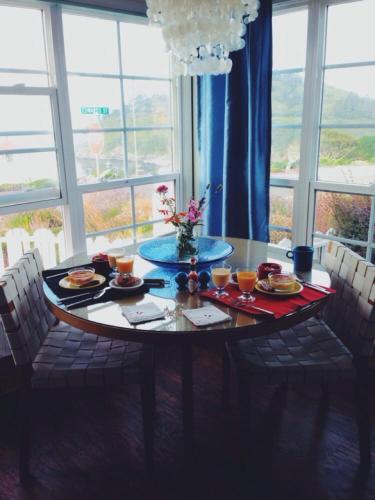 a dining room table with plates of food on it at Lookout At Trinidad Bay in Trinidad