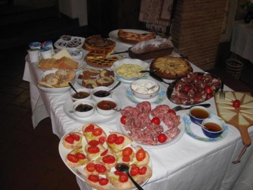 a table with many different types of food on it at La Biocca in Poggio Murella