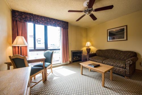 a living room with a couch and a table at The Grand Lodge Hotel and Suites in Mount Crested Butte