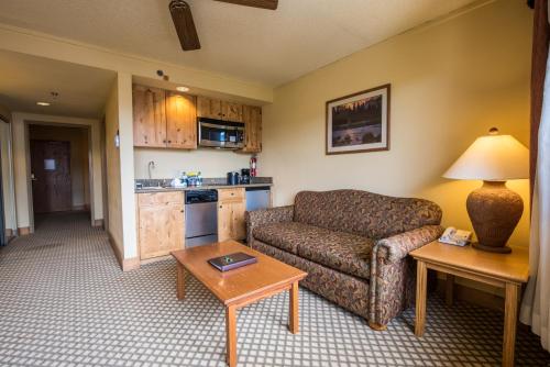 a living room with a couch and a table at The Grand Lodge Hotel and Suites in Mount Crested Butte