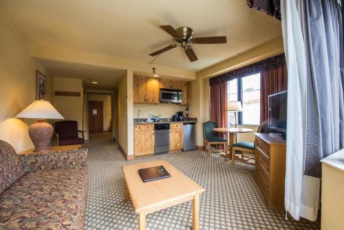 a living room with a couch and a table at The Grand Lodge Hotel and Suites in Mount Crested Butte