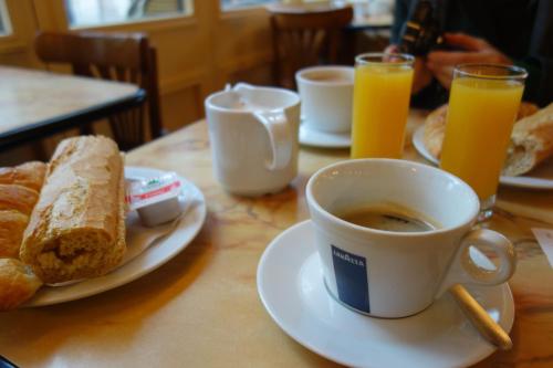 a table with a cup of coffee and a plate of bread at Hostal Buena Tierra in Pucón