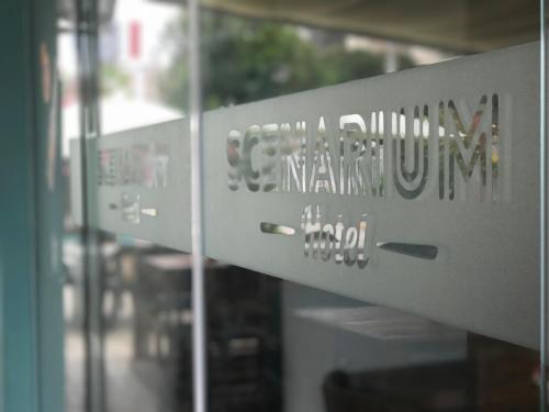 a close up of a sign on a glass door at Scenarium Hotel in Recife