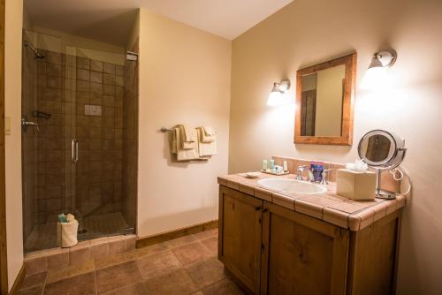 a bathroom with a sink and a shower at The Lodge at Mountaineer Square in Mount Crested Butte