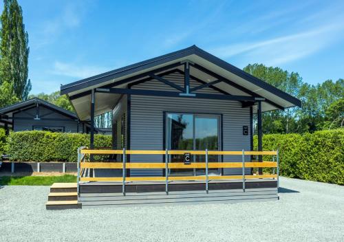 a small tiny house with a black roof at Black on Grey in Geraldine