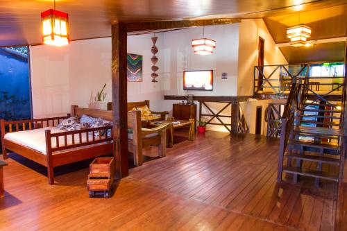 a living room with a couch and a table at Alto do Aeroporto Hotel in Porto Seguro
