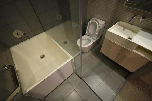 a bathroom with a shower and a toilet and a sink at BoonRumpa Accommodation in Bangkok