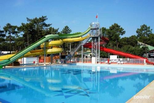 a water slide in a swimming pool with a water park at Village Vacances Bonne Anse Plage in La Palmyre