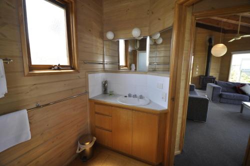 a bathroom with a sink and a living room at 14 Steps in Marengo