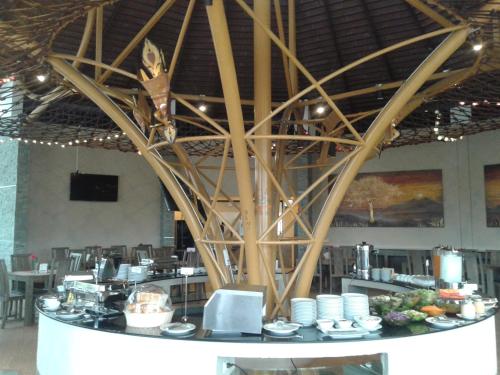 a room with a table with plates and a large ceiling at Phurua Sanctuary Resort and Spa in Phu Rua