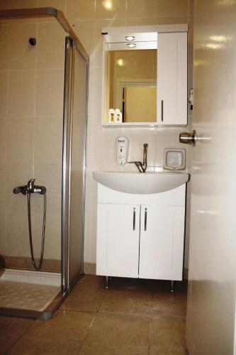 a bathroom with a sink and a shower at Reis Maris Hotel in Marmaris
