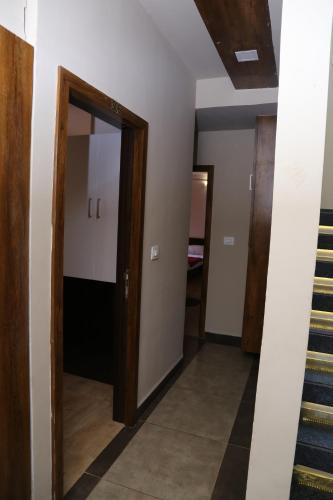 a hallway with a door and stairs in a house at Navaratna Palace in Belgaum